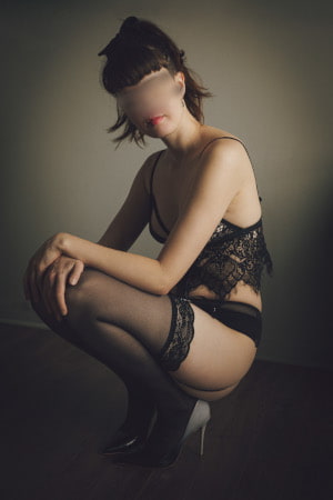 Slim brunette in black lace underwear kneeling