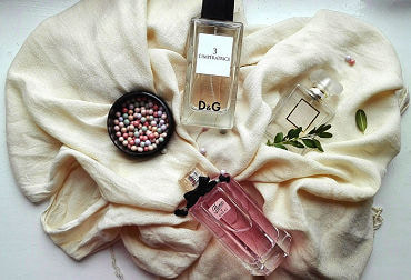 Top 5 Perfumes To Give As A Gift To An Escort Display of 3 bottles of luxury perfume